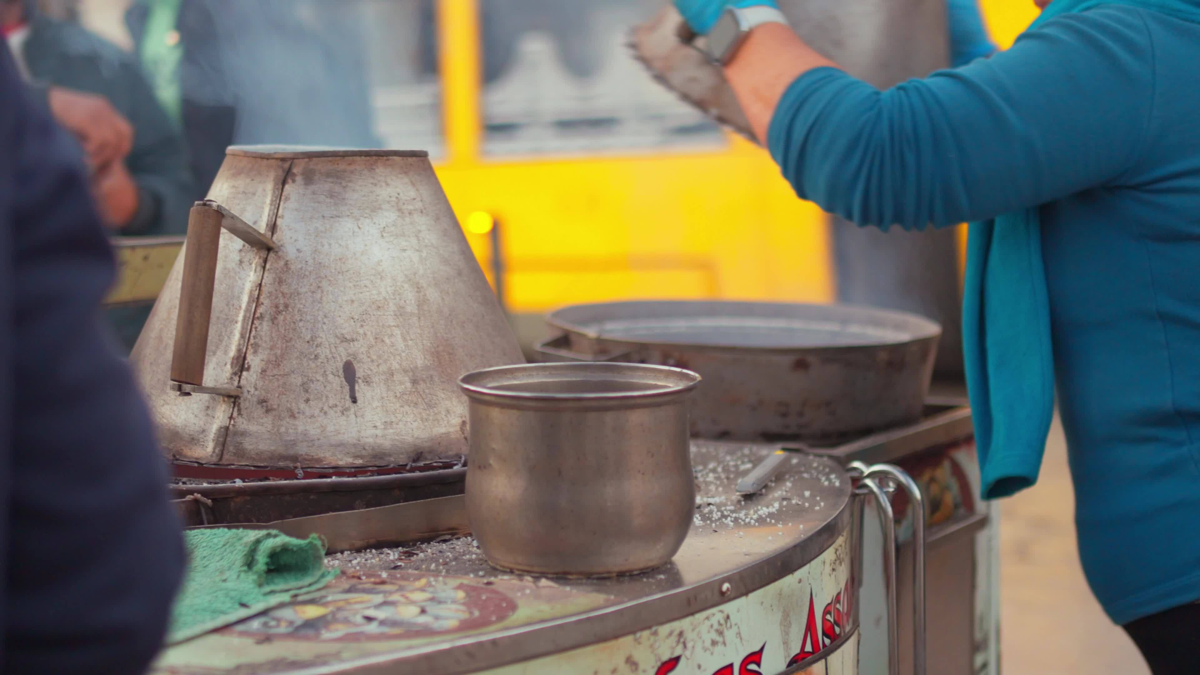 a woman is cooking food on a street food cart 43623394 Stock Video at