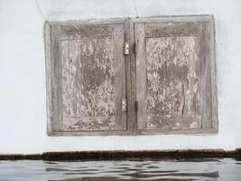 wooden door on white cement wall photo