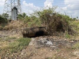 ash and cement tube after burning in garden photo