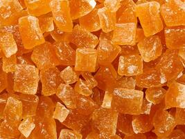 orange sugar cubes as background, close up photo