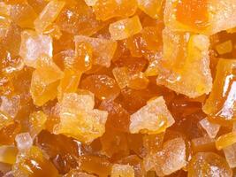 orange sugar cubes as background, close up photo