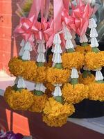 beautiful milkweed and marigold flower garland in market photo