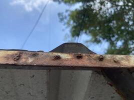 old rusty metal roof and blue sky photo
