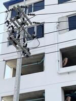 electrician working on a power pole in a city. photo