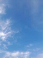 Beautiful white clouds on deep blue sky background. Large bright soft fluffy clouds are cover the entire blue sky. photo