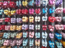 Various types of shoes and sandals displayed in a shoe shop storefront. photo