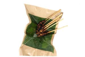 goat satay skewers and banana leaf photo