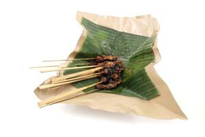 goat satay skewers and banana leaf photo