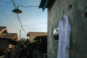 the bride's dress hangs on the wall photo