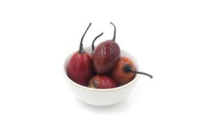 Ripe tamarillo fruit in a white bowl photo