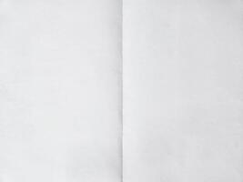 Blank paper folded on two. Background photo