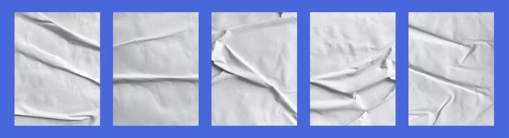 Five white sheets with folds isolated on a black background. photo