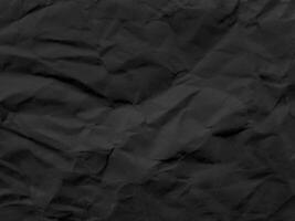 black wrinkled paper texture. crumpled paper photo