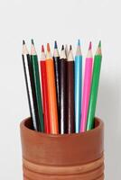 Color pencils standing on white background. close up of colored pencils photo