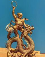 Ang Silla.Chonburi.Thailand - April 06.2024.Naja statue golden is a beautiful Thai and Chinese architecture of Nachas sa thai chute shrine, naja shrine, najasaataichue, nezha shrine chinese temple. photo