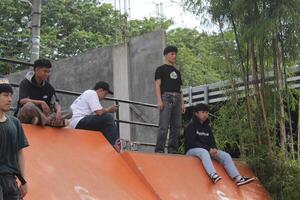 Indonesia - Medan, 17 August 2023 a group of asian people are sitting on the obstacle ramp photo