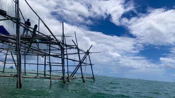 stake charts, traditional fish traps in the sea made of wood photo