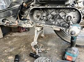 Motorcycle engine servicing is being carried out by a tool photo