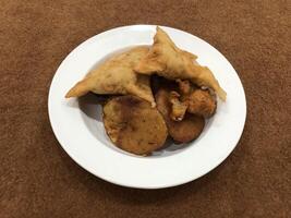 solado parte superior ver de qeema samosa y cuenca pakora en blanco lámina, popular indio o pakistaní calle comida bocadillo en blanco fondo, diwali cena o iftar comida. foto