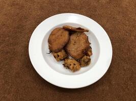 Isolated Basin Pakora, Popular indian or pakistani street food snack on white Plate photo