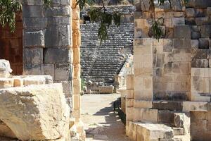 Ancient entrance with stones in arch to amphitheater arena in ancient Lycian city of Patara, Turkey. photo