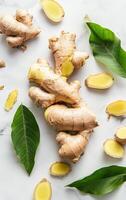 Fresh Ginger Root With Green Leaves on a White Background photo
