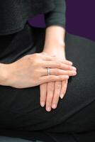 Wedding ring photo shoot concept a man wearing a formal black suit and purple tie and woman with purple suit is holding a wedding ring