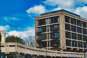 Modern urban apartment building with balconies against a blue sky with fluffy clouds. Architectural exterior of residential structure in a city setting in York, North Yorkshire, England. photo