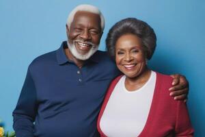 Happy black skin senior couple in blue background. Concept of success in business and life. photo