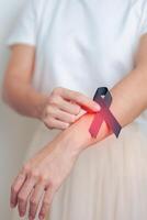 Melanoma and skin cancer, Vaccine injury awareness month and rest in peace concepts. woman holding black Ribbon photo