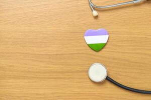 Queer Pride Day and LGBT pride month concept. purple, white and green heart shape with Stethoscope for Lesbian, Gay, Bisexual, Transgender, genderqueer and Pansexual community photo