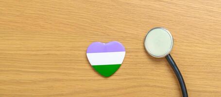 Queer Pride Day and LGBT pride month concept. purple, white and green heart shape with Stethoscope for Lesbian, Gay, Bisexual, Transgender, genderqueer and Pansexual community photo