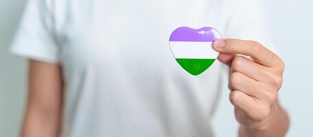 Queer Pride Day and LGBT pride month concept. purple, white and green heart shape for Lesbian, Gay, Bisexual, Transgender, genderqueer and Pansexual community photo