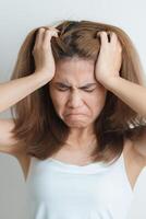 Stress, Sad and unhappy concepts. Alone asian Woman having headache, Young female feeling frustrated, exhausted and suffering photo