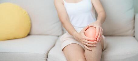 woman having knee ache and muscle pain due to Runners Knee or Patellofemoral Pain Syndrome, osteoarthritis, arthritis, rheumatism and Patellar Tendinitis. medical concept photo