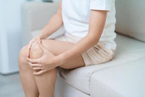 woman having knee ache and muscle pain due to Runners Knee or Patellofemoral Pain Syndrome, osteoarthritis, arthritis, rheumatism and Patellar Tendinitis. medical concept photo