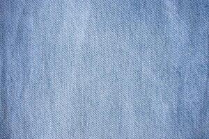 Blue denim texture, light jeans. Blue cotton canvas fabric texture as background photo