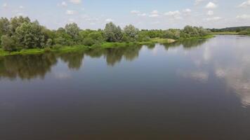 Aerial view of a quiet river and forest at summer sunny day in Belarus video