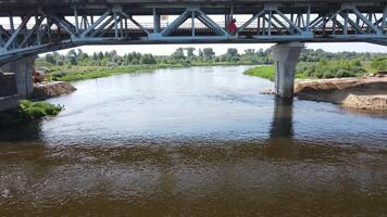 Flying under the bridge.A drone under the bridge next to the overpass flies towards the river. video