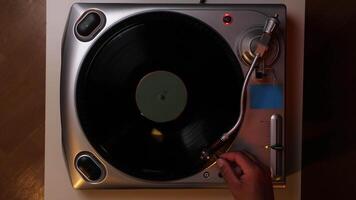 top view Hand turns on a vintage vinyl record video