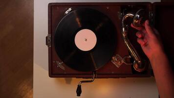 pov top view turning on music playback on an old vintage turntable gramophone video