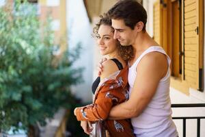 Loving couple in inner wears hugging on balcony outdoors photo