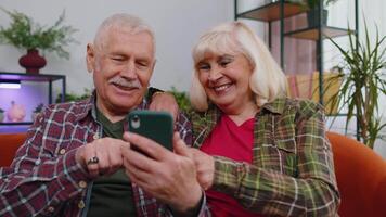 espantado Senior avós usar Móvel Smartphone receber Boa notícia mensagem chocado de de repente vitória video