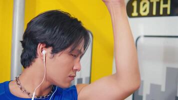 Portrait of a young man in blue, looking pensive, with a blurred urban background. video