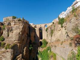 The Puente Nuevo, New Bridge in Ronda. White villages in the province of Malaga, Andalusia, Spain. Beautiful village on the cliff of the mountain. Touristic destination. Holidays and enjoy the sun. photo