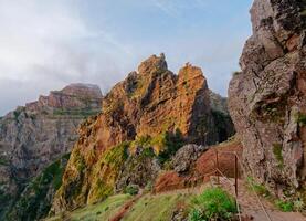 Beautiful mountain landscape view with vibrant colors during a sunny day. Hiking trail of Pico Arieiro to Pico Ruivo, Madeira Island Portugal. Travel the world. Nomad life. Adventurous lifestyle. photo