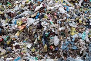 Landfill with garbage in nature. Plastic waste. Environmental issue. photo