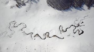 Winter scenery of the Studeni Potok meandering stream located near the village of Umoljani, on the southern side of Bjelasnica, Bosnia and Herzegovina. Beautiful landscapes and rural tourism. photo