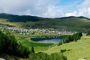 View of Prokosko lake and a village in Bosnia and Herzegovina. Rural life and traditional life. Glacial lake. photo