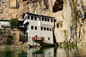 View of Tekija in Blagaj in Bosnia and Herzegovina. The Tekija, dervish house, set at the source of the river Buna. photo